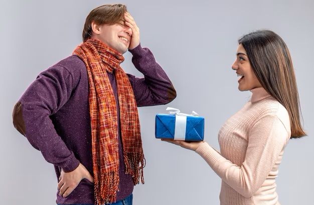 young-couple-on-valentines-day-smiling-girl-giving-gift-box-to-crying-guy-isolated-on-white-background_141793-110423.jpg