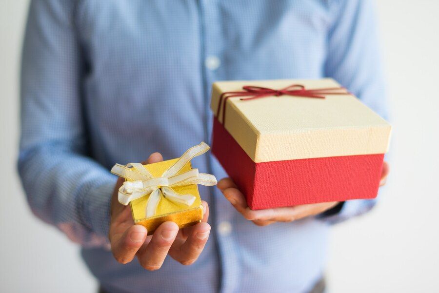 close-up-of-unrecognizable-man-holding-two-gift-boxes_1262-17284.jpg