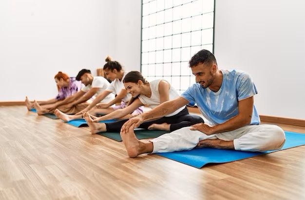 group-of-young-people-smiling-happy-training-yoga-at-sport-center_839833-7403.jpg