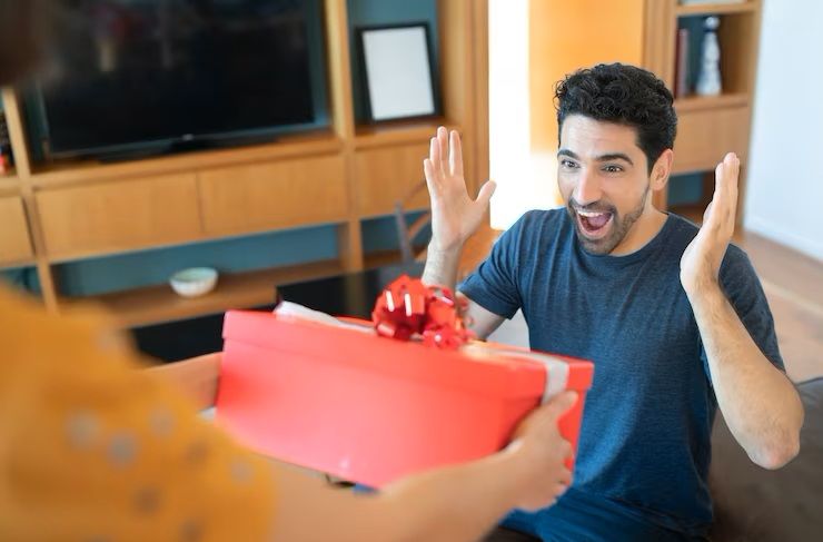 portrait-of-a-woman-surprising-her-boyfriend-with-a-present-celebration-and-valentine-s-day-concept_58466-14645.jpg