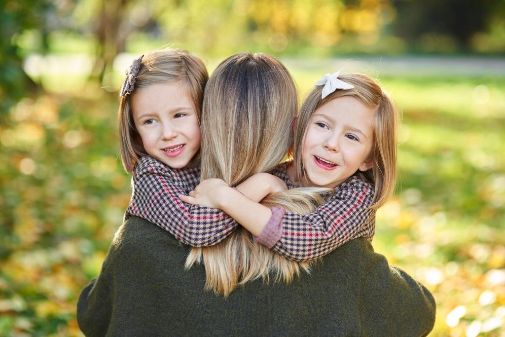 two-little-girls-embracing-their-mom_329181-20432.jpg