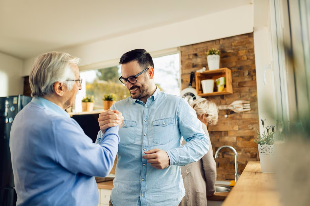 happy-adult-son-his-mature-father-holding-hands-while-greeting-each-other-kitchen_637285-10296.png