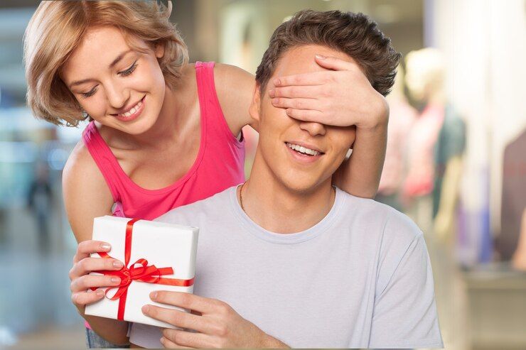 happy-girl-covering-her-boyfriend-s-eyes-with-hands-and-gives-gift_488220-16381.jpg