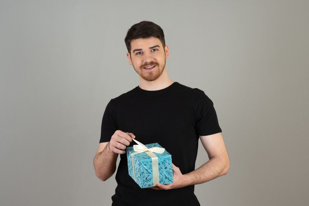 young-bearded-guy-trying-open-present-grey_144627-64085.jpg