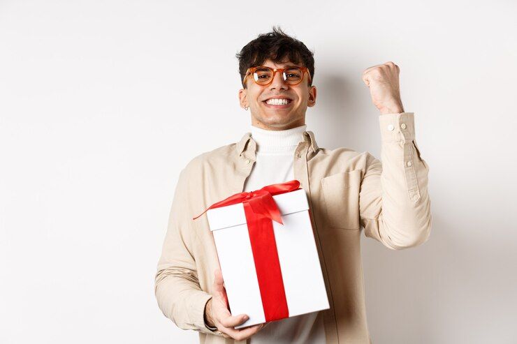 cheerful-guy-saying-yes-as-receiving-gift-making-fist-pump-and-rejoicing-got-present-standing-on-white-background_1258-65714.jpg