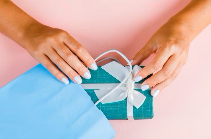 hands-putting-gift-box-into-paper-bag_176474-8938.jpg