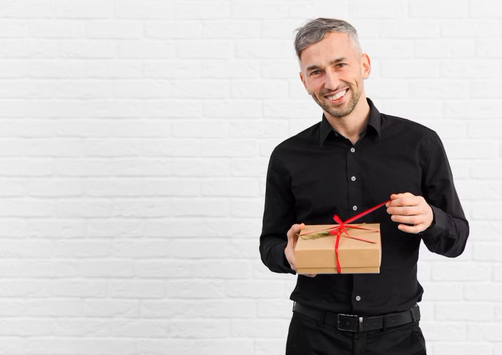 man-in-black-suit-unwrapping-a-gift_23-2148401448.jpg