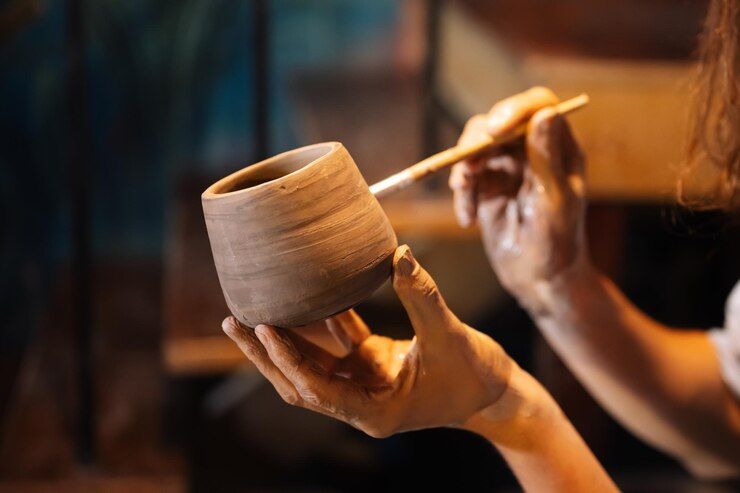 professional-craftsman-potter-making-jug-of-clay-on-potter-wheel-circle-in-workshop_336744-114.jpg