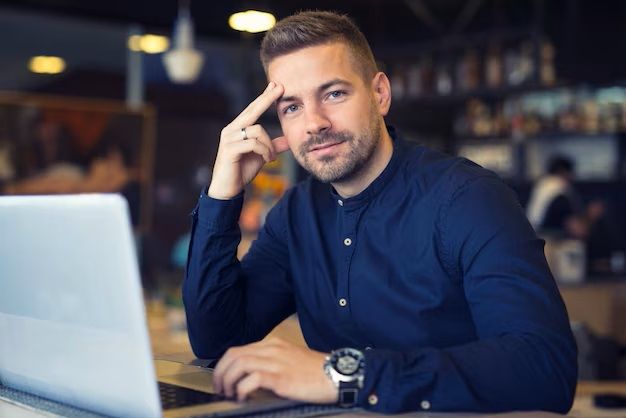 young-businessman-siting-at-cafeteria-with-laptop-computer-on-the-table_342744-455.jpg