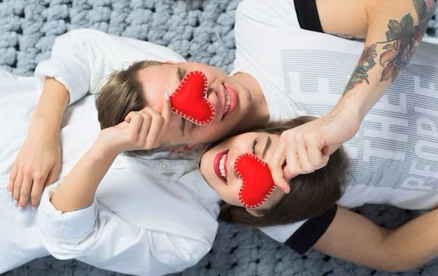 couple-holding-red-toy-hearts-at-faces_23-2148013242.jpg
