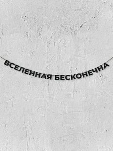 Гирлянда из чёрных букв «Вселенная бесконечна»
